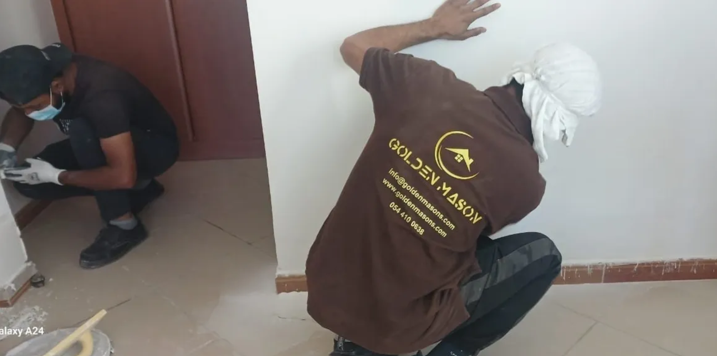 Tile mason laying floor tiles during a renovation