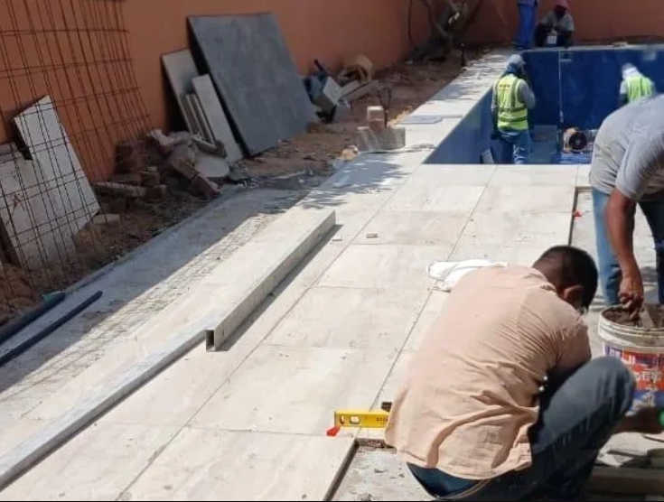 Tile mason laying floor tiles during a renovation