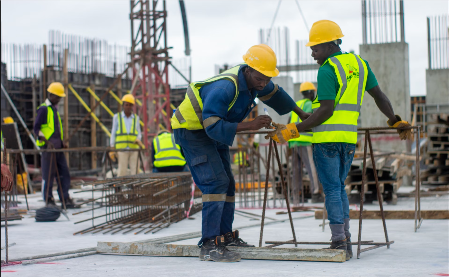 Construction crew in safety gear working on a Dubai building site