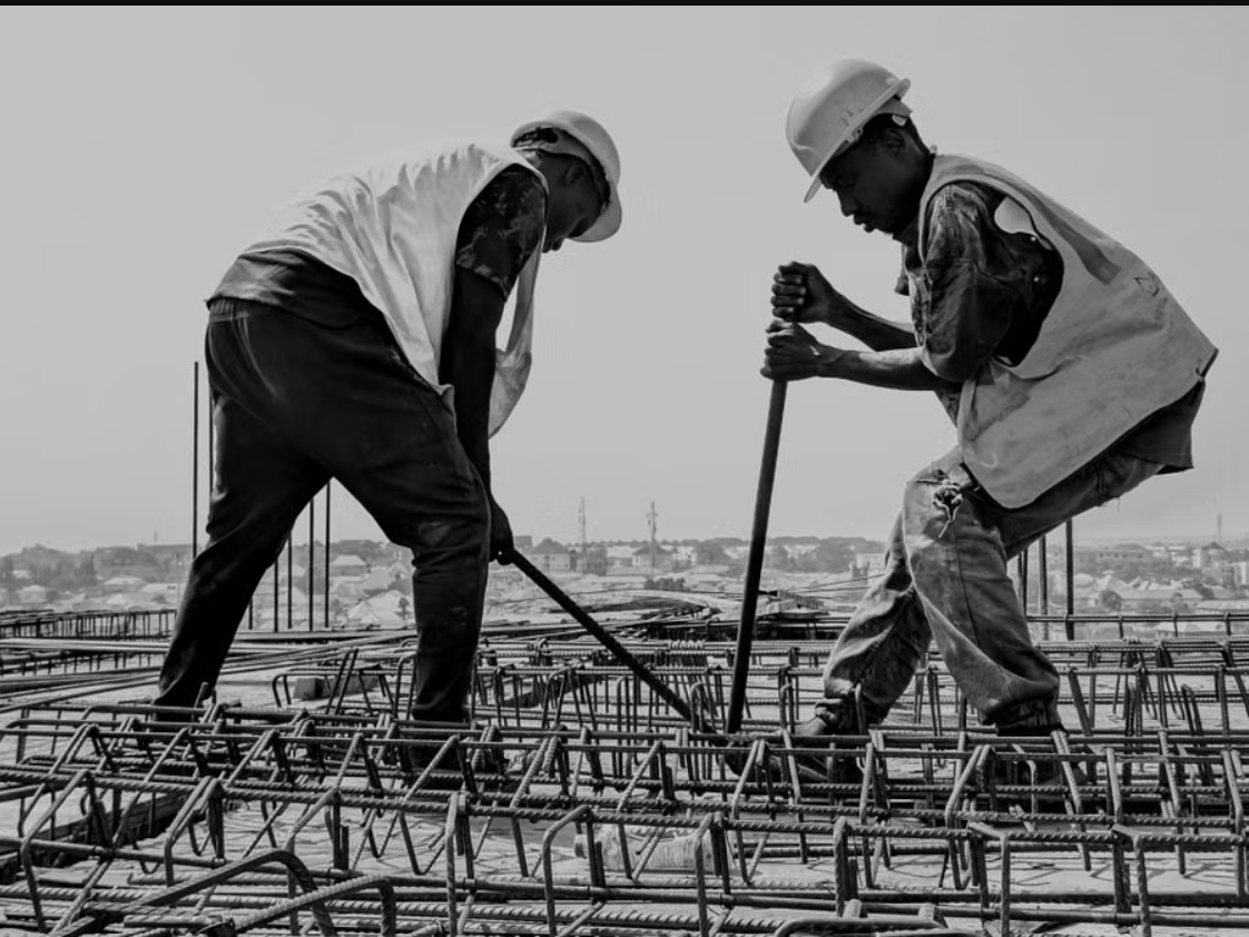 Steel fixers tying reinforcement bar on a construction site