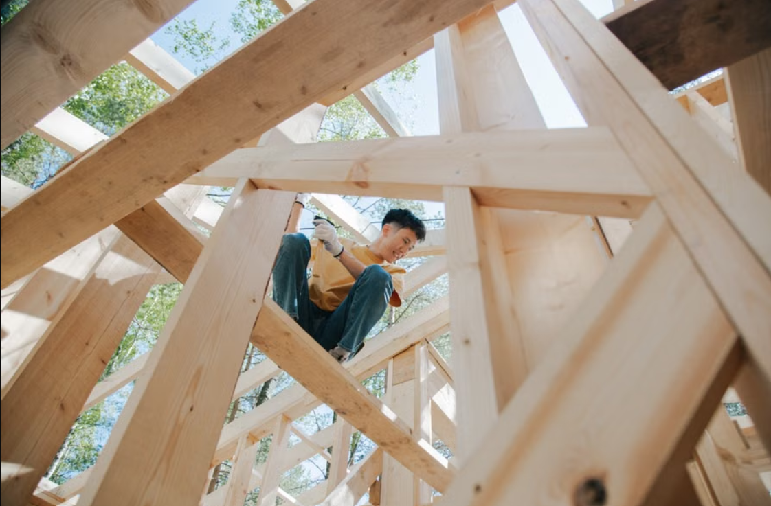 Carpenter building timber formwork structure at a construction site